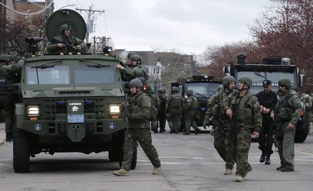 A SWAT team unloaded from their armored vehicles on April 19. 2013. (Charles Krupa/AP)