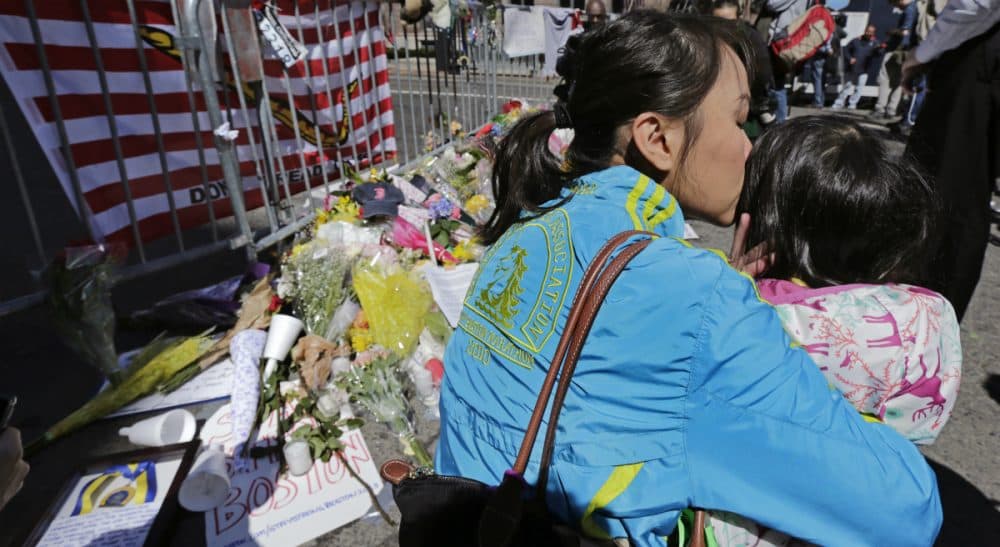 Sharon Brody: Worrying is folly. It represents a flailing effort to gain, or to pretend to gain, some power over the unpredictable comings and goings of life. In this photo, Boston Marathon runner Vu Trang, of San Francisco, kisses her two-year-old daughter Cara at a makeshift memorial on Boylston Street, April 17, 2013. (Charles Krupa/AP)