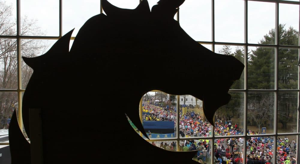 A year has passed since the bombing at the Boston Marathon, but what exactly does that mean? In this photo, behind a silhouette of the Boston Athletic Association logo, runners start the 117th running of the Boston Marathon, in Hopkinton, Mass., Monday, April 15, 2013. (Stew Milne/AP)