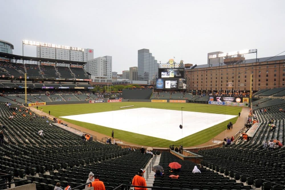 Professional baseball teams use tarps to protect their fields. (Mitchell Layton/Getty Images)