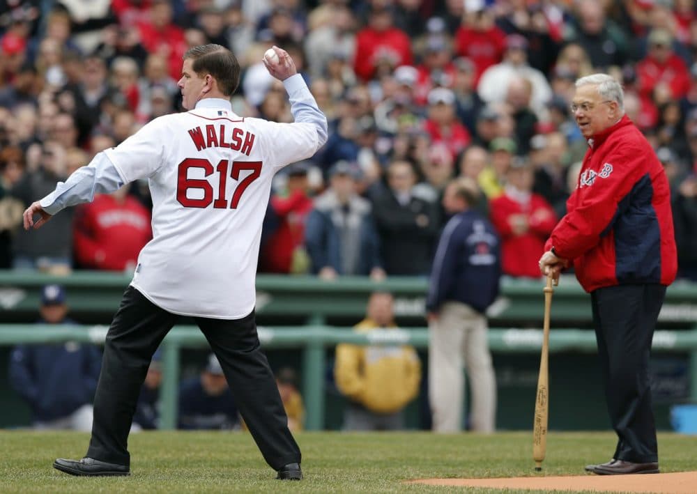 Boston Mayor Marty Walsh throws the ceremonial first pitch as his predecessor in office Tom Menino looks on before a baseball game between the Boston Red Sox and the Milwaukee Brewers. (Michael Dwyer/AP)