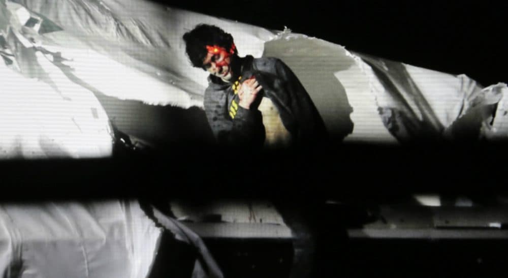 In this Friday, April 19, 2013, file photo provided by the Massachusetts State Police, Boston Marathon bombing suspect Dzhokhar Tsarnaev leans over in a boat at the time of his capture by law enforcement authorities in Watertown, Mass. (Sean Murphy/AP)