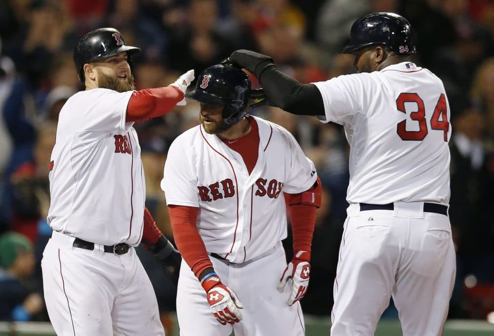 David Ortiz (34) and Mike Napoli, left, celebrate after scoring a on a three-run home run by Jonny Gomes, center, in the sixth inning. (Michael Dwyer/AP)
