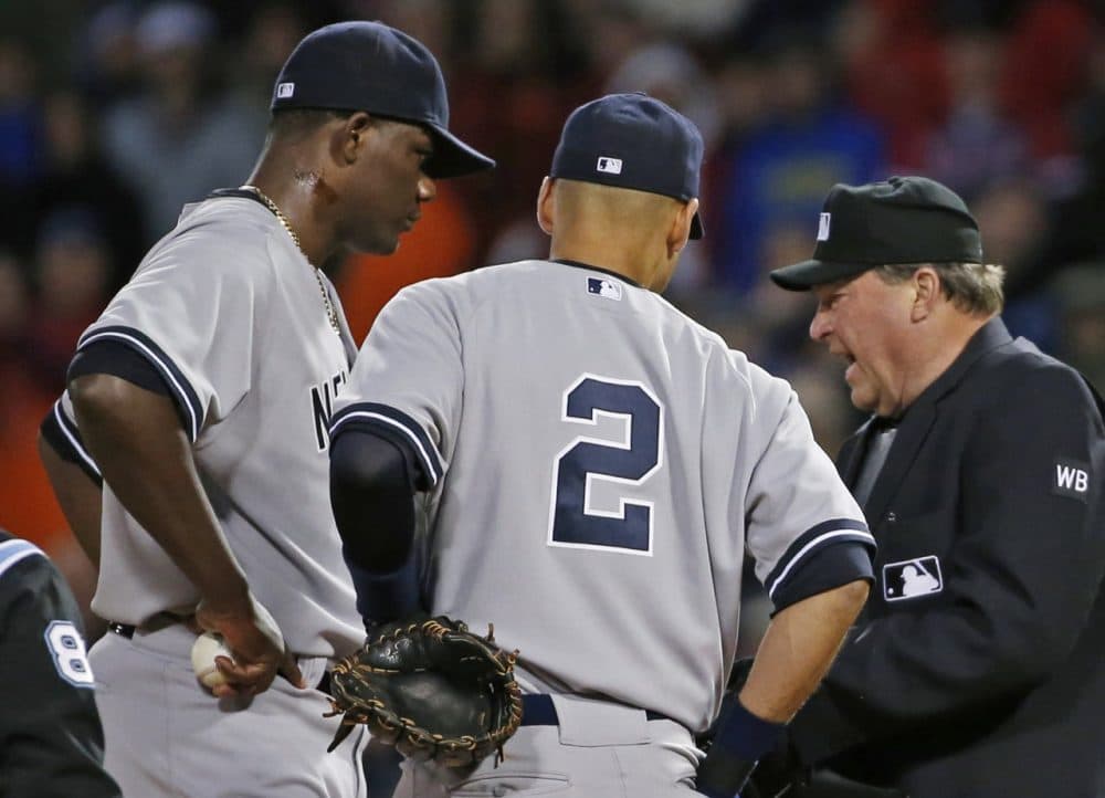 Home plate umpire Gerry Davis confers on the mound with New York Yankees starting pitcher Michael Pineda. (Elise Amendola/AP)