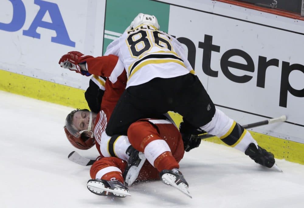Boston Bruins defenseman Kevan Miller (86) takes down Detroit Red Wings left wing Justin Abdelkader (8) and is called for roughing during the second period. (AP/Carlos Osorio)