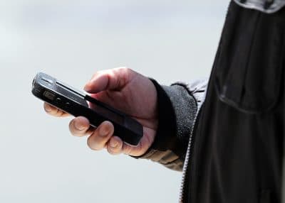 A pedestrian uses a smartphone as he walks along Market Street on June 5, 2013 in San Francisco, California. (Justin Sullivan/Getty Images)
