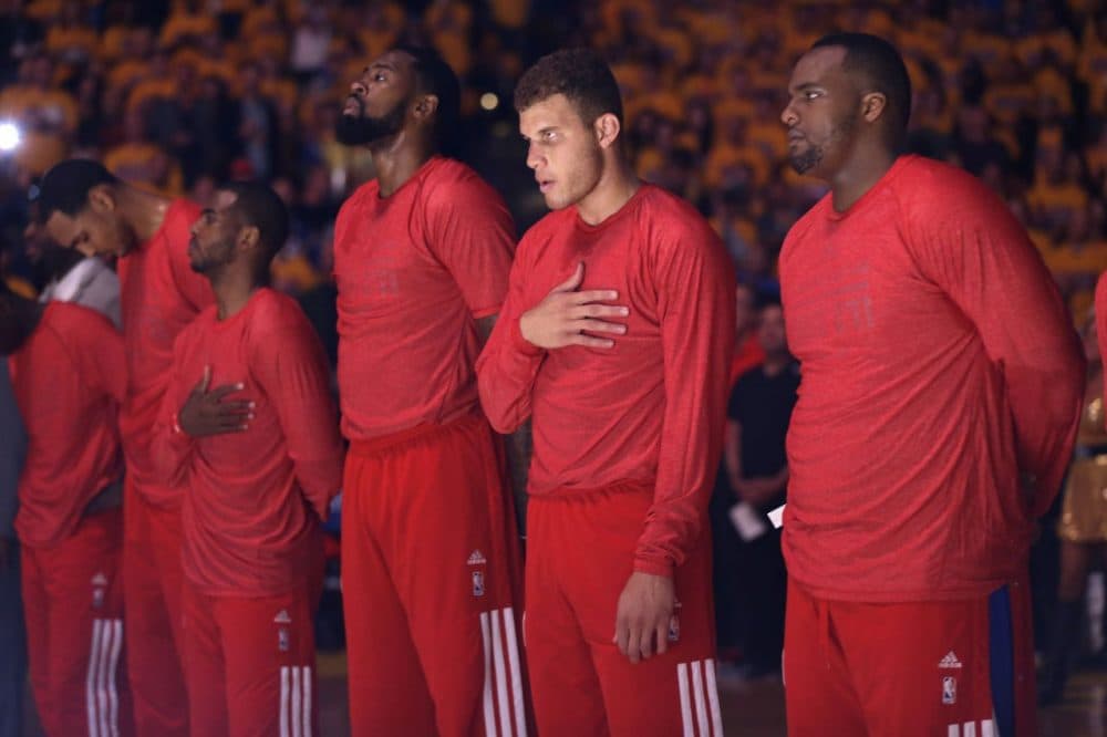 Los Angeles Clippers players listen to the national anthem wearing their warmup jerseys inside out to protest alleged racial remarks by team owner Donald Sterling. (Marcio Jose Sanchez/AP)