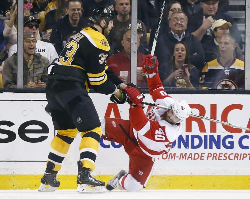 With his size and reach, the Bruins' 6-foot-9 Zdeno Chara is a big problem for opposing forwards. Here, Chara checks Detroit Red Wings' Henrik Zetterberg in Game 5. (Michael Dwyer/AP)