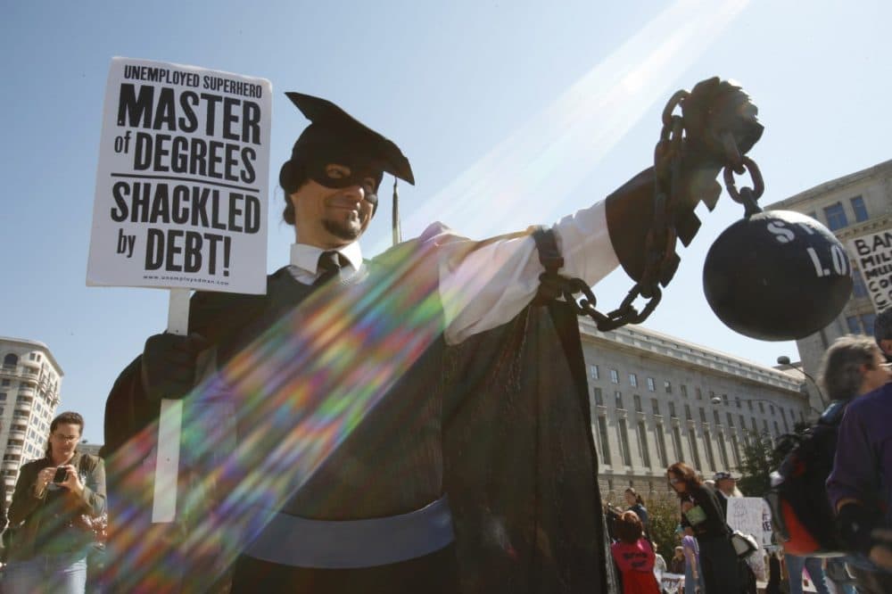 In this Oct. 6, 2011 photo, Gan Golan, of Los Angeles, dressed as the &quot;Master of Degrees,&quot; holds a ball and chain representing his college loan debt, during Occupy DC activities in Washington. As President Obama prepared to announce new measures Wednesday to help ease the burden of student loan debt, new figures painted a demoralizing picture of college costs for students and parents: Average in-state tuition and fees at four-year public colleges rose an additional $631 this fall, or 8.3 percent, compared with a year ago. (AP)