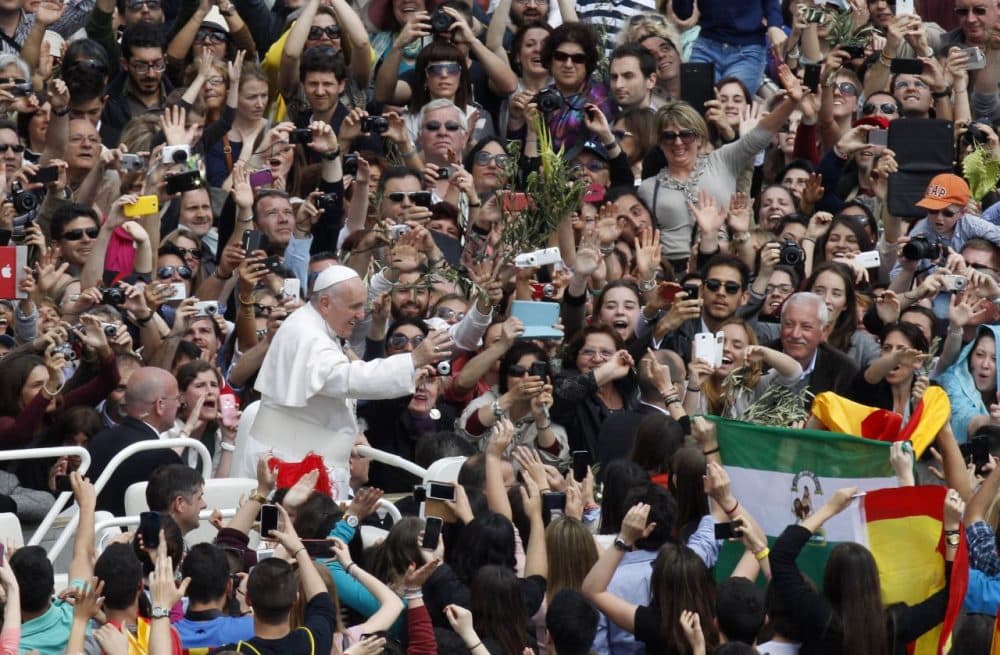 Pope Francis greets faithful at the end of the Palm Sunday Mass in St. Peter's square at the Vatican, Sunday, April 13, 2014. (Riccardo De Luca/AP)