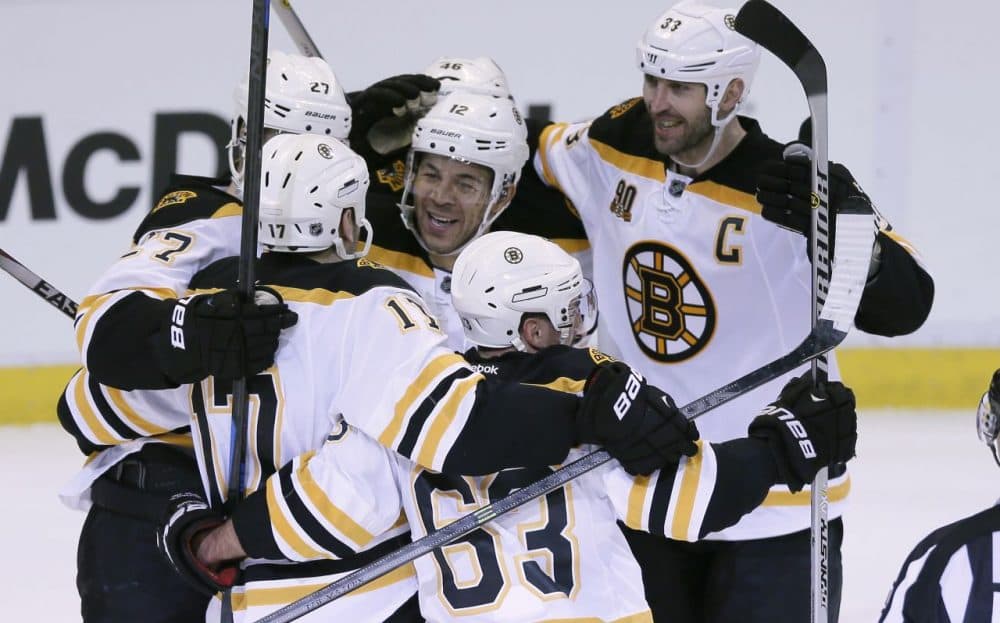 Boston Bruins right wing Jarome Iginla, center, is mobbed by teammates as they celebrate their 3-2 overtime win in Game 4 of a first-round NHL hockey playoff series against the Detroit Red Wings in Detroit, Thursday, April 24, 2014. Iginla was credited with the winning goal. (Carlos Osorio/AP)