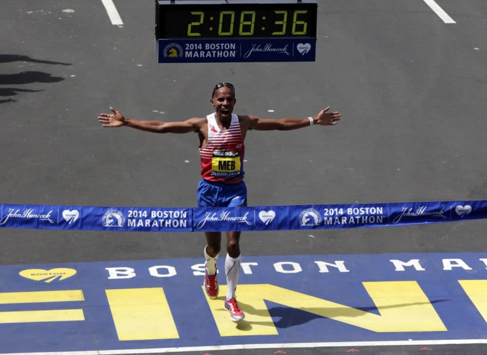 Meb Keflezighi, of San Diego, Calif., celebrates as he crosses the finish line to win the 118th Boston Marathon, Monday, April 21, 2014, in Boston. (AP)