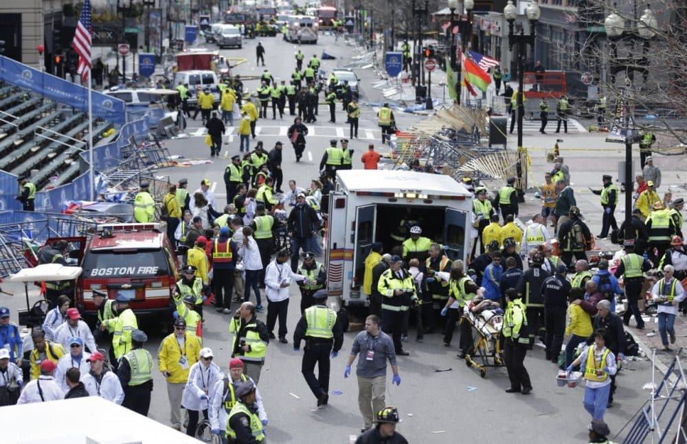 Medical workers aid injured people at the finish line of the 2013 Boston Marathon following an explosion in Boston, Monday, April 15, 2013. (AP)