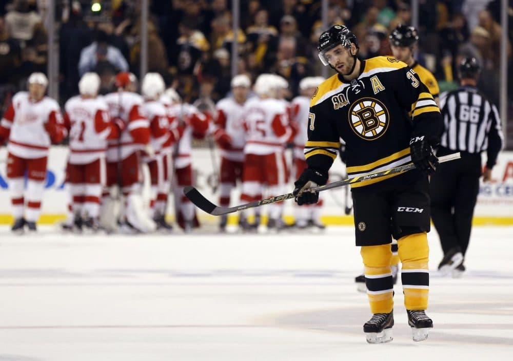 Bruins' Patrice Bergeron skates off the ice as the Detroit Red Wings celebrate their 1-0 win in Game 1 of a first-round NHL playoff hockey series, in Boston on Friday. (Winslow Townson/AP)