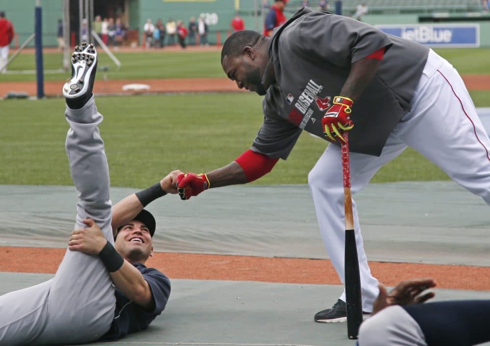 Boston Red Sox's David Ortiz, right, reaches down to greet a former teammate, New York Yankees' Jacoby Ellsbury, prior to a baseball game at Fenway Park in Boston, Tuesday, April 22, 2014. (AP)