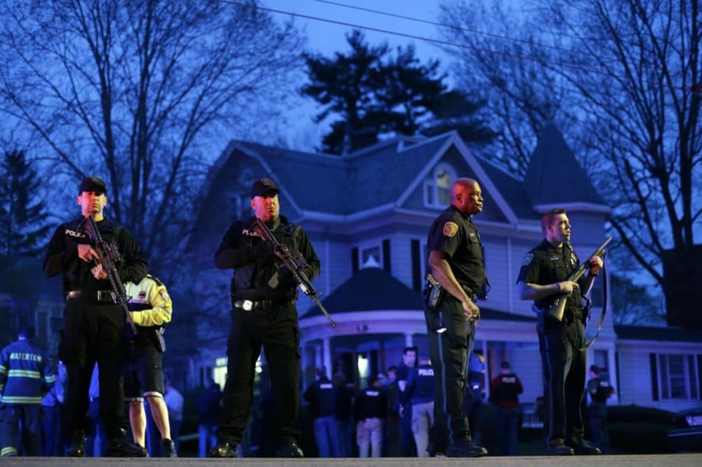 Police officers guard the entrance to Franklin street where there is an active crime scene search for the suspect in the Boston Marathon bombings, Friday, April 19, 2013, in Watertown, Mass. (AP/Matt Rourke)