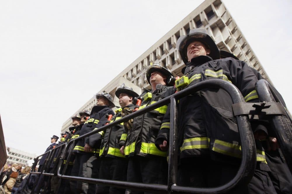 Firefighters from Ladder 15 and Engine 33 during a Boston Fire Department flag raising ceremony in honor of fallen firefighters Michael R. Kennedy and Lt. Edward J. Walsh. (AP/Stephan Savoia)