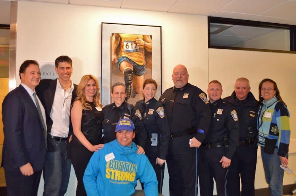 Boston Marathon bombing survivor Heather Abbott and a group of first responders helped unveil Brian Fox's painting &quot;Endurance,&quot; which will hang at Spaulding Rehab's Charlestown facility. (Courtesy) 
