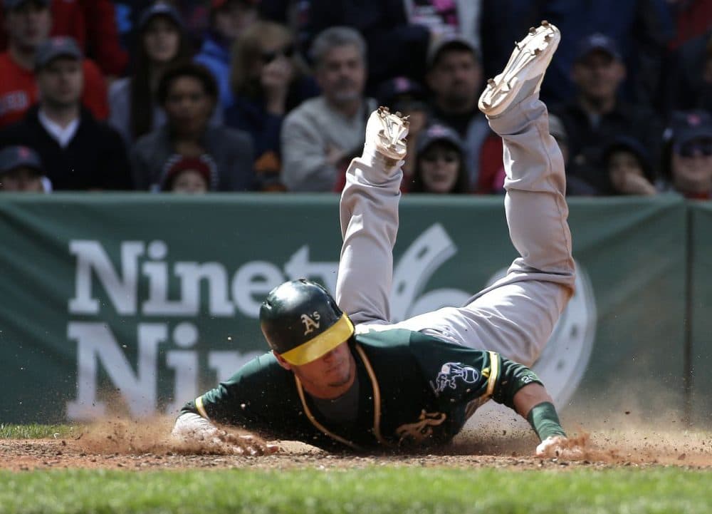 Oakland Athletics' Josh Donaldson slides home to score on a hit by Yoenis Cespedes in the sixth inning. (Steven Senne/AP)