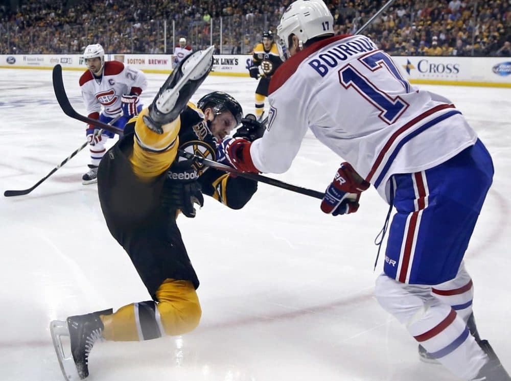 Montreal Canadiens left wing Rene Bourque (17) dumped Boston Bruins defenseman Kevan Miller to the ice during the first period in Game 2, but the Bruins evened the series with a 5-3 win. (Elise Amendola/AP) 