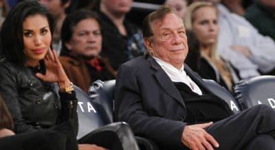 Los Angeles Clippers owner Donald Sterling, right, and V. Stiviano, left, watch the Clippers play the Los Angeles Lakers during an NBA preseason basketball game in Los Angeles on Monday, December 19, 2011. (Danny Moloshok/AP)