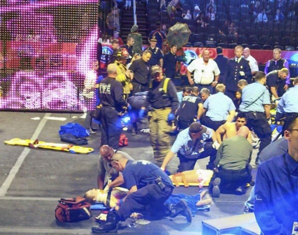 First responders asses performer injuries after a platform collapsed during an aerial hair-hanging stunt at a Ringling Brothers and Barnum and Bailey Circus performance in Rhode Island in May. (Rose Viveiros/AP) 
