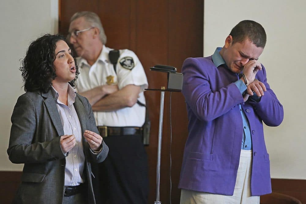 Kevin Edson cries during a hearing as he stands beside his attorney, Shannon Lopez, left, in Municipal Court last month. (Boston Herald/John Wilcox/AP/Pool)