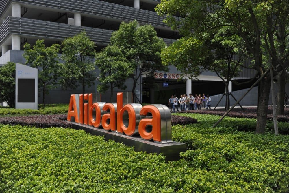 Chinese workers walk out from the Alibaba head office building in Hangzhou, in eastern China's Zhejiang province on May 21, 2012. (STR/AFP/GettyImages)