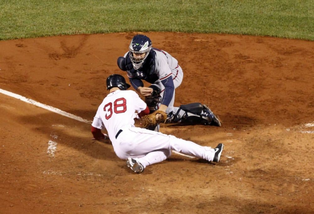 Atlanta Braves catcher Evan Gattis puts the tag on Boston Red Sox's Grady Sizemore (38) who is out trying to score on a fielder's choice in the sixth inning of a baseball game. (AP/Elise Amendola)