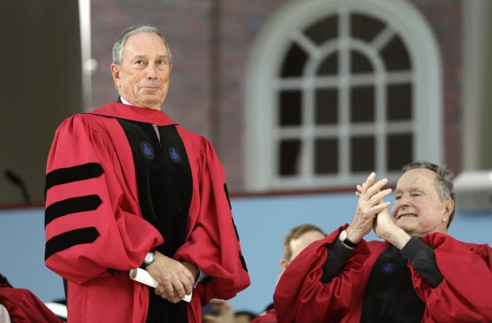 Former Mayor of New York Michael Bloomberg receives applause from former President George H. W. Bush as receives an honorary degree during Harvard's commencement ceremonies. (Steven Senne/AP)