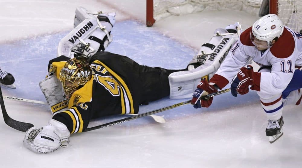 Bruins goalie Tuukka Rask (40) dives out of the crease to cover the puck while pressured by Montreal Canadiens right wing Brendan Gallagher (11) during the second period  in Boston, Saturday. (Charles Krupa/AP)