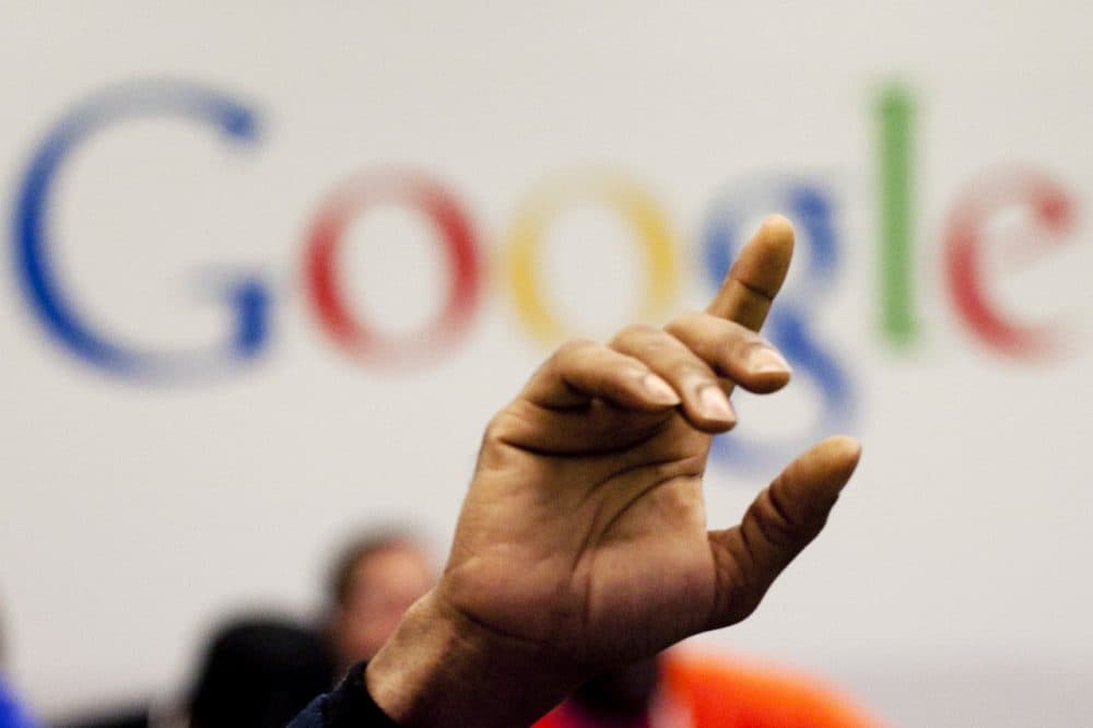  In this Oct. 17, 2012, file photo, a man raises his hand during at Google offices in New York. People should have some say over the results that pop up when they conduct a search of their own name online, Europe's highest court said Tuesday, May 13, 2014. (AP)