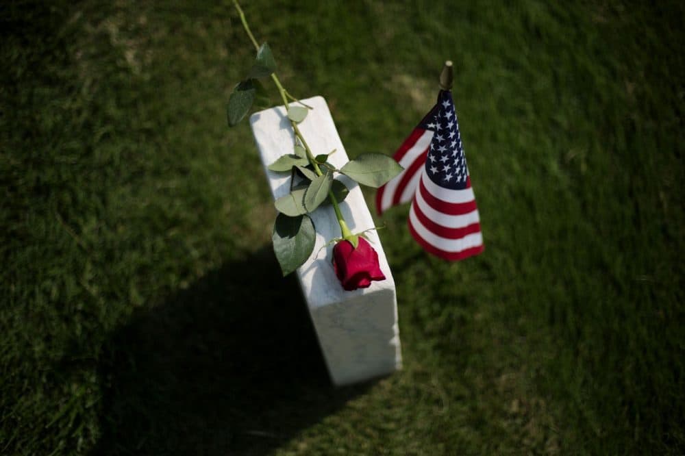 A rose sits on a tombstone of a civl war soldier at Marietta National Cemetery on Memorial Day, Monday, May 26, 2014, in Marietta, Ga. (AP)