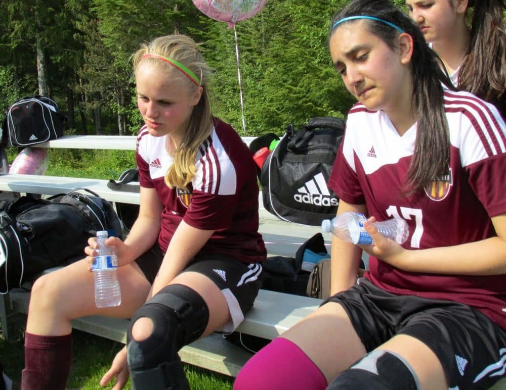 Angel Spurgeon and Vonni Spigai rest during halftime in their first game against Sitka. (Emily Files)