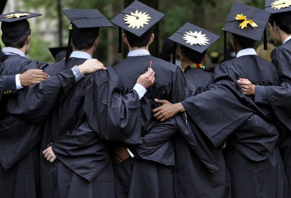 Graduates pose for photographs during commencement at Yale University. (/Jessica Hill/AP)