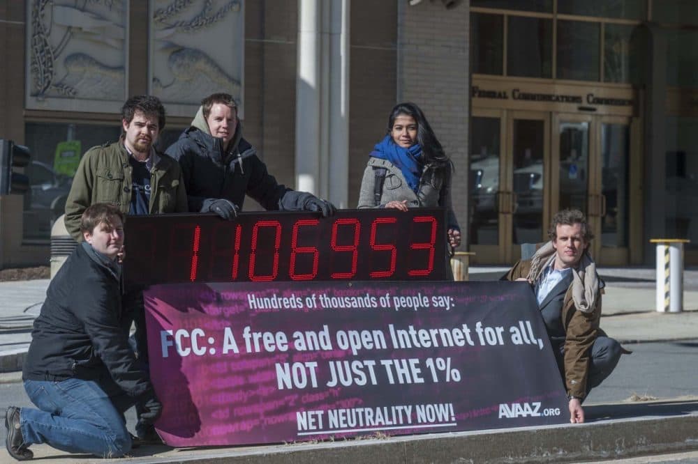 Members of global advocacy group Avaaz stand next to a digital counter showing the number of petition signatures calling for net neutrality outside the Federal Communication Commission in Washington, Thursday, Jan. 30, 2014. Avaaz joined other US advocacy groups to deliver more than a million signatures for a free and democratic internet to the FCC. (AP)