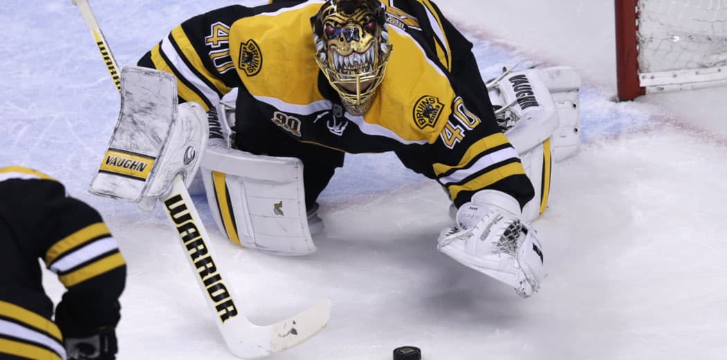 Boston Bruins goalie Tuukka Rask pounces on a loose puck against the Montreal Canadiens during the second period of  the second-round of the Stanley Cup hockey playoff series in Boston, Saturday, May 3, 2014. (AP Photo/Charles Krupa)
