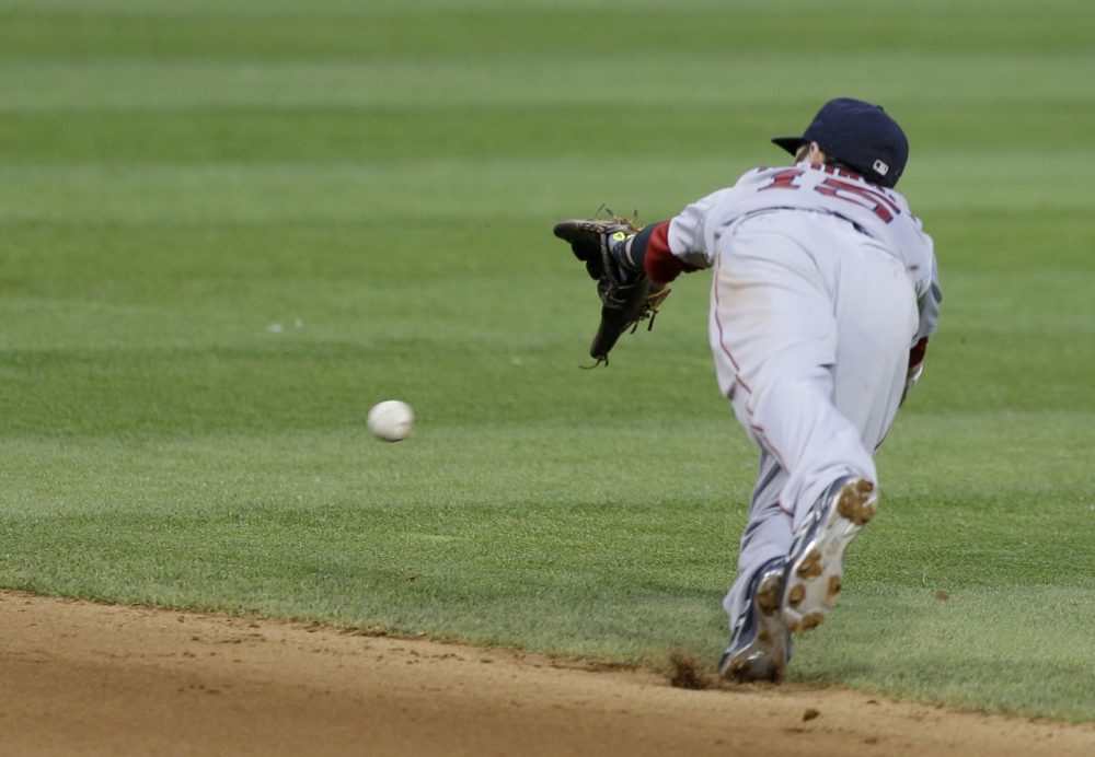 Boston Red Sox's Dustin Pedroia dives but can't get to a single hit by Cleveland Indians' David Murphy. (AP/Tony Dejak)