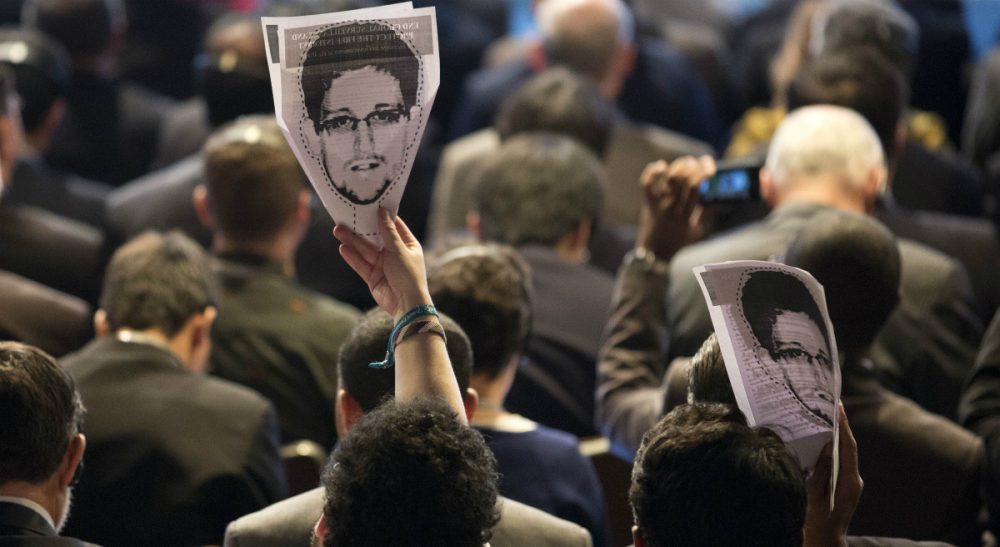 Is former NSA analyst Edward Snowden a 'traitor' who betrayed his country, or a 'whistle-blower' who sparked an important conversation about the limits of surveillance? In this photo, participants hold up images of Snowden during a conference on the future of Internet governance in Sao Paulo, Brazil, Wednesday, April 23, 2014. (Andre Penner/AP) 