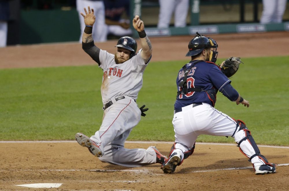 Boston Red Sox's Jonny Gomes, left, scores as Cleveland Indians catcher Yan Gomes waits for the ball in the sixth inning. (AP/Tony Dejak)