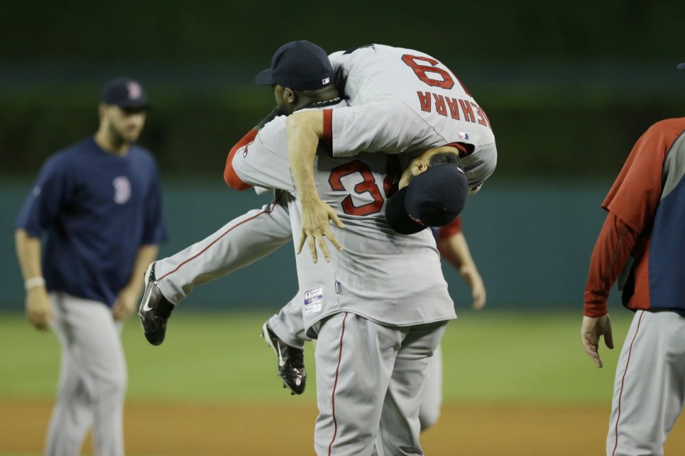 David Ortiz picks up relief pitcher Koji Uehara after Boston's 5-3 win over the Detroit Tigers. (Carlos Osorio/AP)