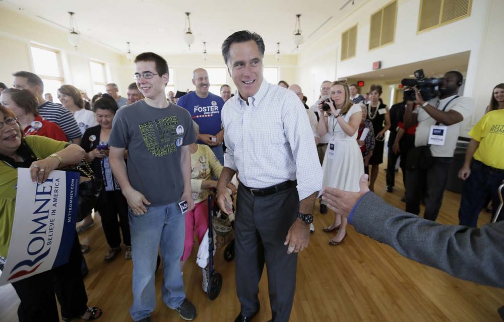 Mitt Romney greets supporters before speaking at a rally for Iowa Republican Senate candidate Joni Ernst in Cedar Rapids, Iowa last month. Romney is trying to re-emerge as a force in Republican politics.  (Charlie Neibergall/AP)