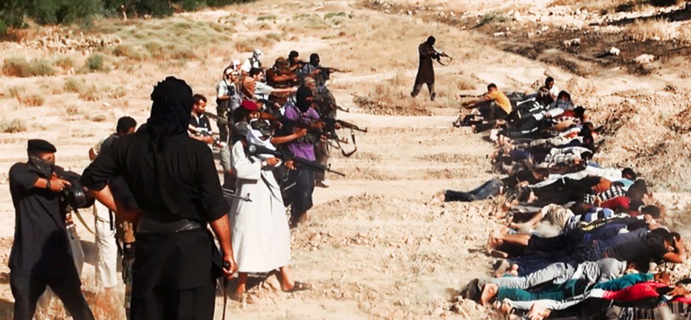 This image posted on a militant website on Saturday, June 14, 2014, which has been verified and is consistent with other AP reporting, appears to show militants from the al-Qaida-inspired Islamic State in Iraq and Syria (ISIS) taking aim at captured Iraqi soldiers wearing plain clothes after taking over a base in Tikrit, Iraq. (AP Photo via militant website)
