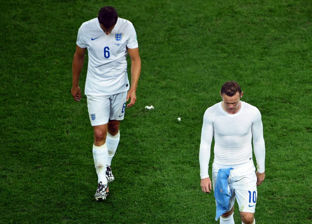 England's Wayne Rooney and Phil Jagielka (left) walk off the pitch following their loss to Uruguay, 2-1. England is now eliminated from the World Cup. (Matthias Hangst/Getty Images)