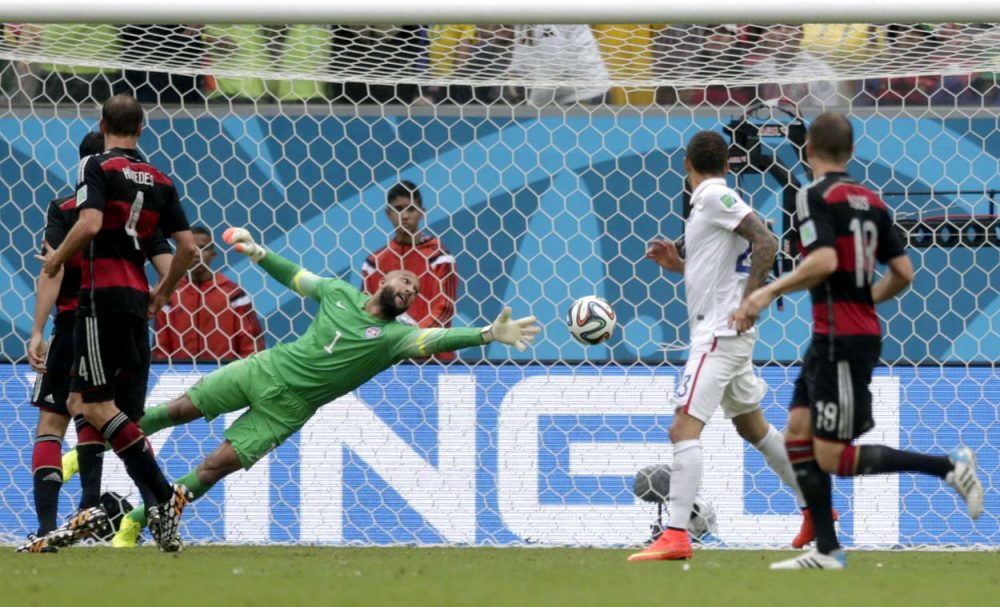 U.S. goalkeeper Tim Howard can't stop a shot by Germany's Thomas Mueller during the group G World Cup soccer match between the United States and Germany at the Arena Pernambuco in Recife, Brazil Thursday. (Julio Cortez/AP)