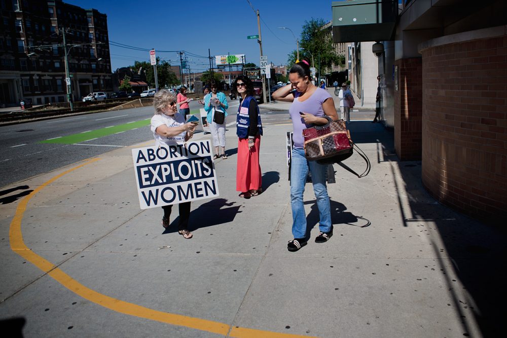 Protesters hand out literature outside a Boston Planned Parenthood a day after the U.S. Supreme Court ruled that the 35-foot buffer zone around Massachusetts abortion clinics violates free speech. (Jesse Costa/WBUR)