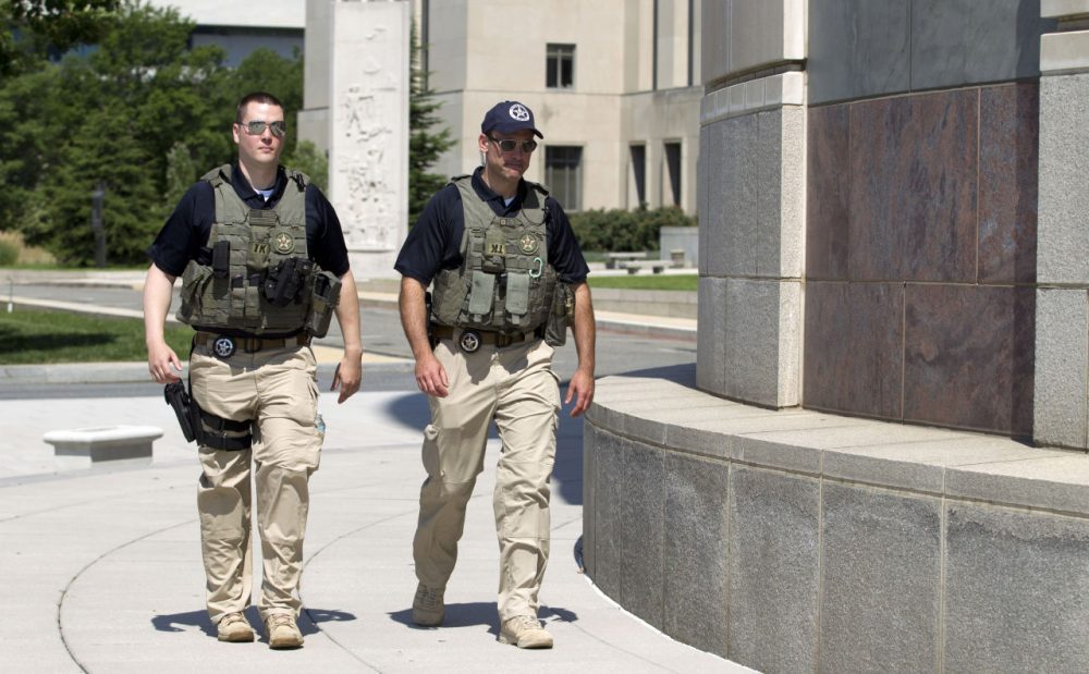 U.S. Marshalls move outside the federal U.S. District Court in Saturday after security was heightened in anticipation of a possible court appearance by captured Libyan militant Ahmed Abu Khattala later in the day.  (Jose Luis Magana/AP)