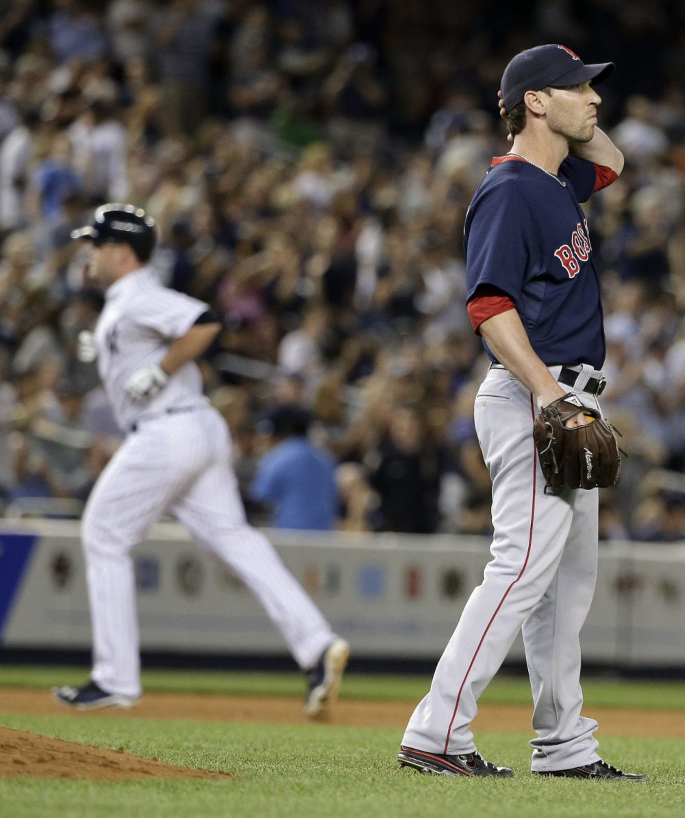 Boston Red Sox pitcher Craig Breslow, right, reacts after giving up a two-run home run to New York Yankees' Brian McCann, left. (AP Photo/Julie Jacobson)
