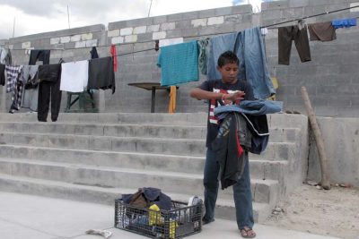 Brian Duran, 14, of Comayagua, Honduras collects his line-dried laundry at the Senda de Vida migrant shelter in Reynosa, Mexico, June 3, 2014. Duran traveled alone to the U.S.-Mexico border and hopes to soon become one of the more than 47,000 unaccompanied children to enter the United States since Oct. 1, 2013. (AP)