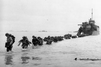 U.S. reinforcements wade through the surf from a landing craft in the days following D-Day and the Allied invasion of Nazi-occupied France at Normandy in June 1944 during World War II.  (AP)